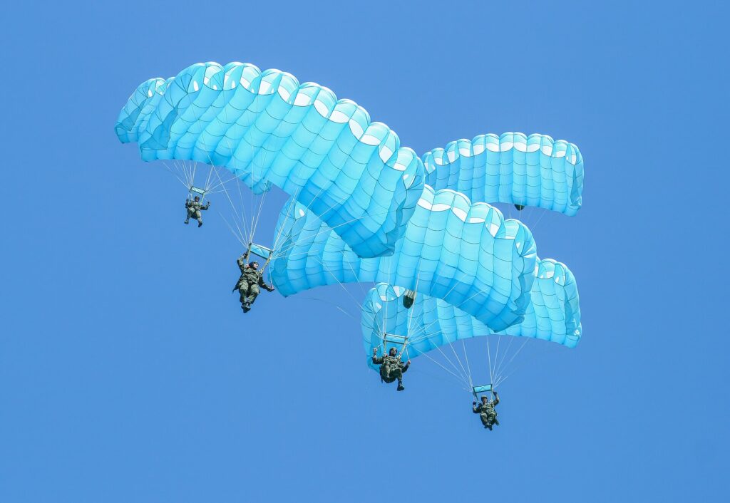 Parachute canopies under a blue sky